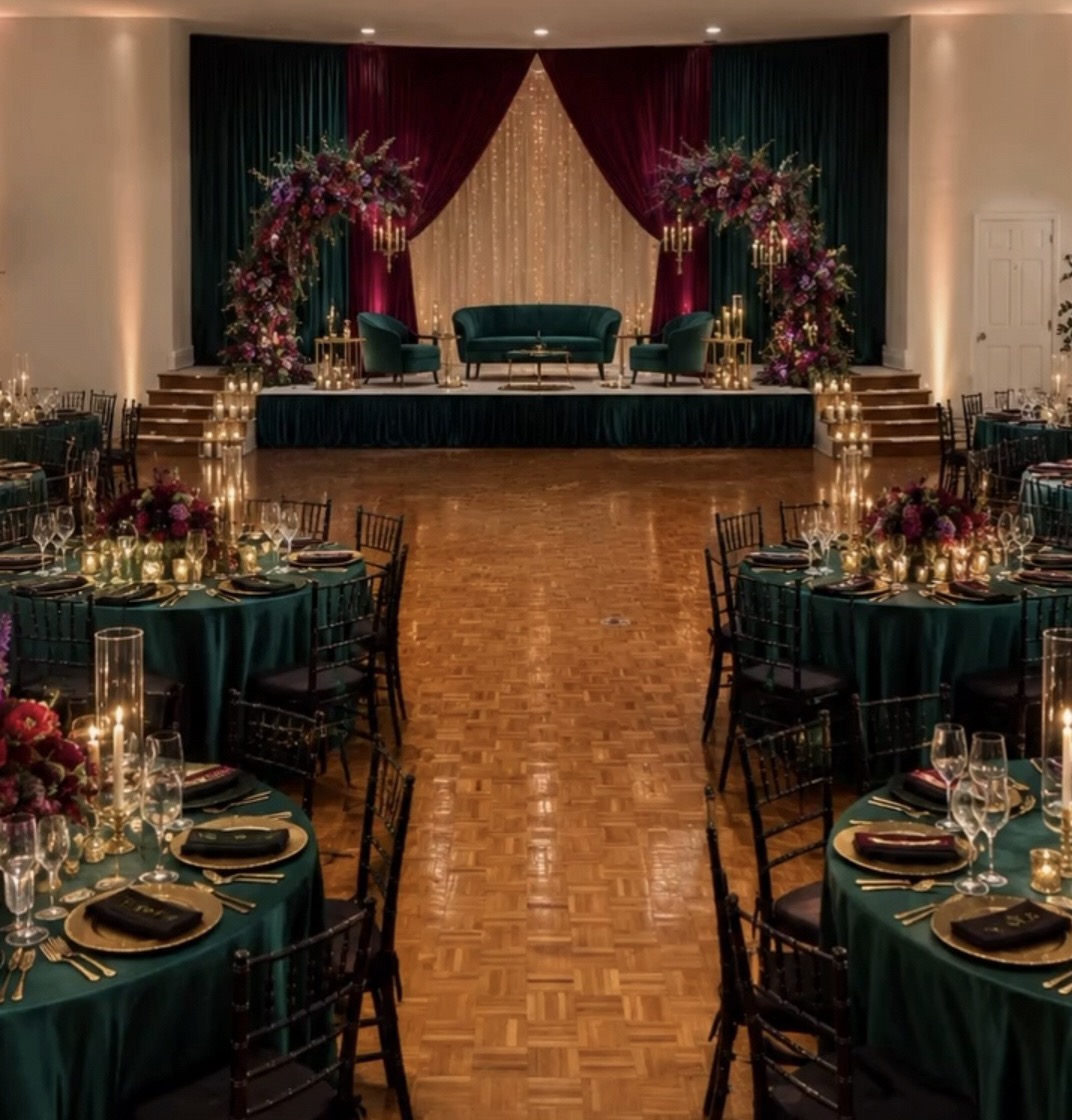 The upper floor with a raised stage, drapery and a parquet dance floor set for an evening event
